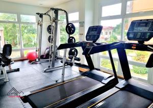 a gym with two treadmills and a treadmill at Palawan 1BR Summer Get-away Deluxe with Balcony FREE Pool and Gym - T2 6 Diamond in Puerto Princesa City