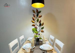 a dining room table with a plant on the wall at Palawan 1BR Summer Get-away Deluxe with Balcony FREE Pool and Gym - T2 6 Diamond in Puerto Princesa City