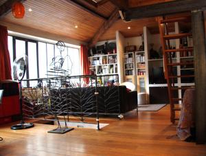 a living room with a large window and a couch at Loft character with a view of court in Paris