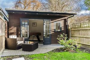 a small shed with a pool table in it at Cozy 3 Bedroom Terrace Cottage in Epsom in Epsom