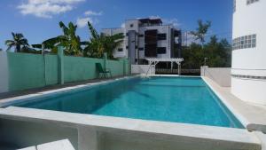 a swimming pool on the side of a building at See Belize Sea View Vacation Rentals in Belize City