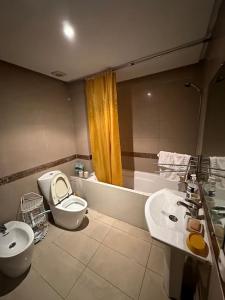 a bathroom with a toilet and a bidet and a sink at La maison est belle et a tout. in Casablanca