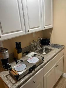 a kitchen counter with a stove and a sink at Unforgettable Stay in Orlando 1 in Orlando