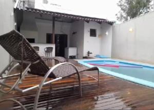 una piscina con sillas junto a una piscina en Pousada Claudia e Juliano en São Gabriel