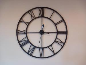 a large black and white clock on a wall at Roomy Penthouse 2 double bed apartment - Spacious - Central Beeston - Free secure parking - in Nottingham
