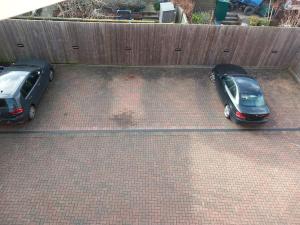 two cars are parked in a parking lot at Roomy Penthouse 2 double bed apartment - Spacious - Central Beeston - Free secure parking - in Nottingham