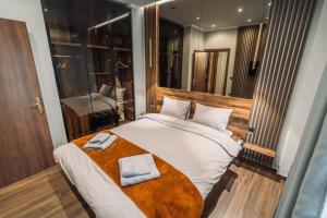 um quarto com uma cama grande com duas toalhas em INDIVIDUALliving 1 em Tessalónica
