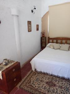 sypialnia z łóżkiem i komodą obok łóżka w obiekcie MIRADOR DEL LAGO - La Vista w mieście Villa Parque Siquiman