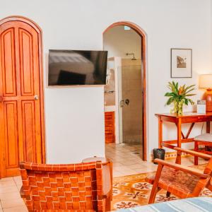 a living room with a television on a refrigerator at Hotel Boutique Adela in Granada