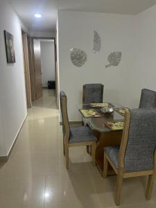 uma sala de jantar com mesa e cadeiras em Cozy Apartment with pool em Montería