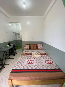 a bedroom with two beds and a table in it at Jugalbot Tourist Inn in San Francisco