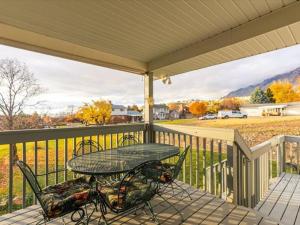 a patio with a table and chairs on a balcony at Close to Mountain View Park King Bed Spacious Yard in Harrisville