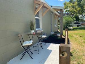 a patio with two chairs and a table next to a house at Walking Distance to University Mall Big Backyard in Orem