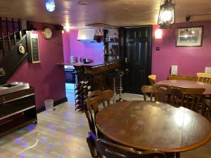 a dining room with a table and a bar at Jacks Court B3 in Ashton under Lyne