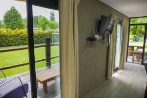 a room with a screened in porch with a television at La Damasca in Mendoza