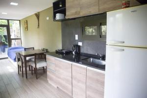 a kitchen with a table and a white refrigerator at La Damasca in Mendoza