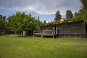 a small house in a yard with a green lawn at La Damasca in Mendoza