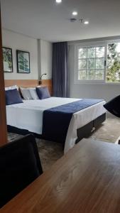 Postel nebo postele na pokoji v ubytování STUDIO ALTO PADRÃO ITAIPAVA