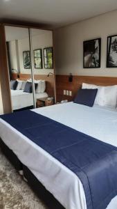 Postel nebo postele na pokoji v ubytování STUDIO ALTO PADRÃO ITAIPAVA + 11 fotografií