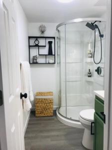 a white bathroom with a shower and a toilet at 10515 Houston Avenue in Hudson