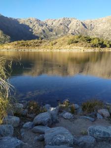 - une vue sur un lac avec des montagnes en arrière-plan dans l'établissement Rincón de sol, à Cortaderas