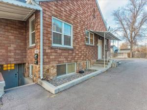 a brick house with a garage and a driveway at 4 BR Duplex Centrally Located Patio Pet Allowed in Provo