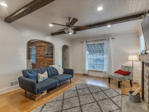 a living room with a blue couch and a ceiling fan at 4 BR Duplex Centrally Located Patio Pet Allowed in Provo
