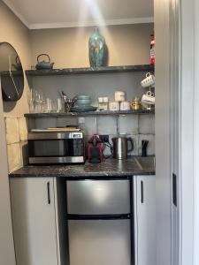 a kitchen with a counter top with a microwave at The Belfry in Taupo