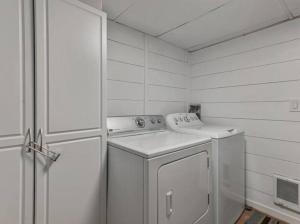 a white laundry room with a washer and a door at Centrally Located in the Heart of Provo 2 BR in Provo
