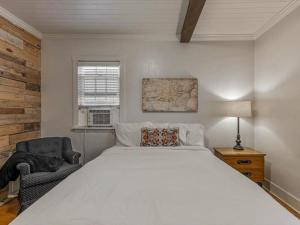 a bedroom with a large white bed and a chair at Cozy Getaway in Central Provo in Provo