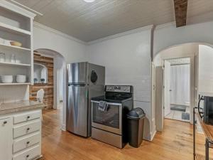 a kitchen with a refrigerator and a stove at Cozy Getaway in Central Provo in Provo