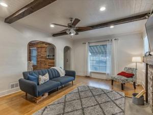a living room with a blue couch and a ceiling fan at Cozy Getaway in Central Provo in Provo