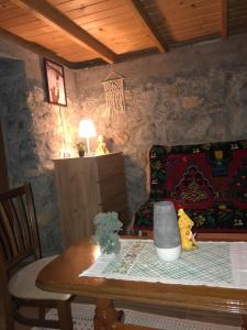 a living room with a table and a couch at Vikendice Suvo Do in Berane