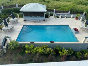 an overhead view of a swimming pool on a patio at De' Seaside Escape in Wickhams