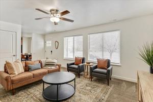 a living room with a couch and chairs and a ceiling fan at Two Kitchens Large Backyard Two Units in Springville