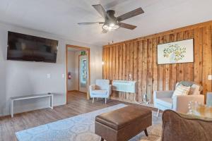 a living room with wooden walls and a ceiling fan at Mountain View Gem BHBungalows #2 in Custer