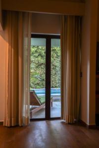 an open glass door with a view of a balcony at Soul Spring Sanctuary in Xochitepec