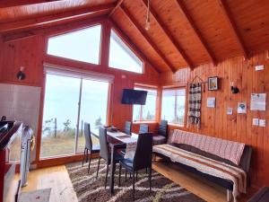 a living room with a table and a couch at Cabañas Bosquemar 1 in Queilén