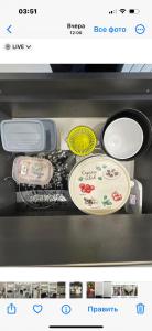 a drawer of an appliance with plates and pans at Cozy holiday home in Yerevan