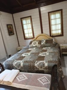 En eller flere senge i et værelse på Casa Agradável, 50m da Praia Freguesia do Ribeirão da Ilha