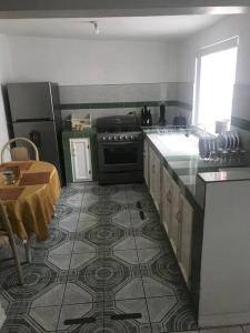 a kitchen with a stove and a tile floor at Prívate and quiet. in Chihuahua