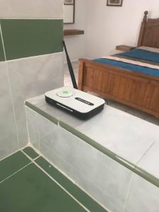 a remote control sitting on a glass table next to a bed at Prívate and quiet. in Chihuahua