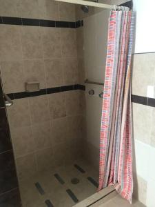 a shower with a shower curtain in a bathroom at Prívate and quiet. in Chihuahua