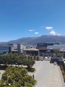 a view of a building with trees in front of it at Departamento Amoblado en Quito Norte, sector la Udla Universidad Av Granados in Quito