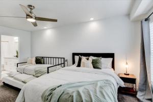 a white bedroom with a bed and a ceiling fan at King Bed Modern Kitchen and Living Room in Vineyard
