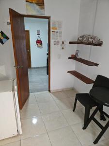 a room with a table and a chair and a door at El Hostal By Pochet in San Andrés