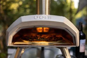 a pizza is being cooked in an oven at Stay Wilder Sunshine Coast in Sechelt