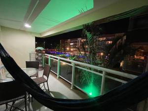 a hammock on a balcony with a view of a city at Apart Vg Fun in Fortaleza