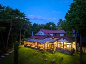 a large house with a lot of windows at Village Kagetsuen in Yamanakako