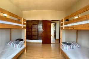 two bunk beds in a room with wooden floors at La Casa del Teide, d-espacios in La Orotava